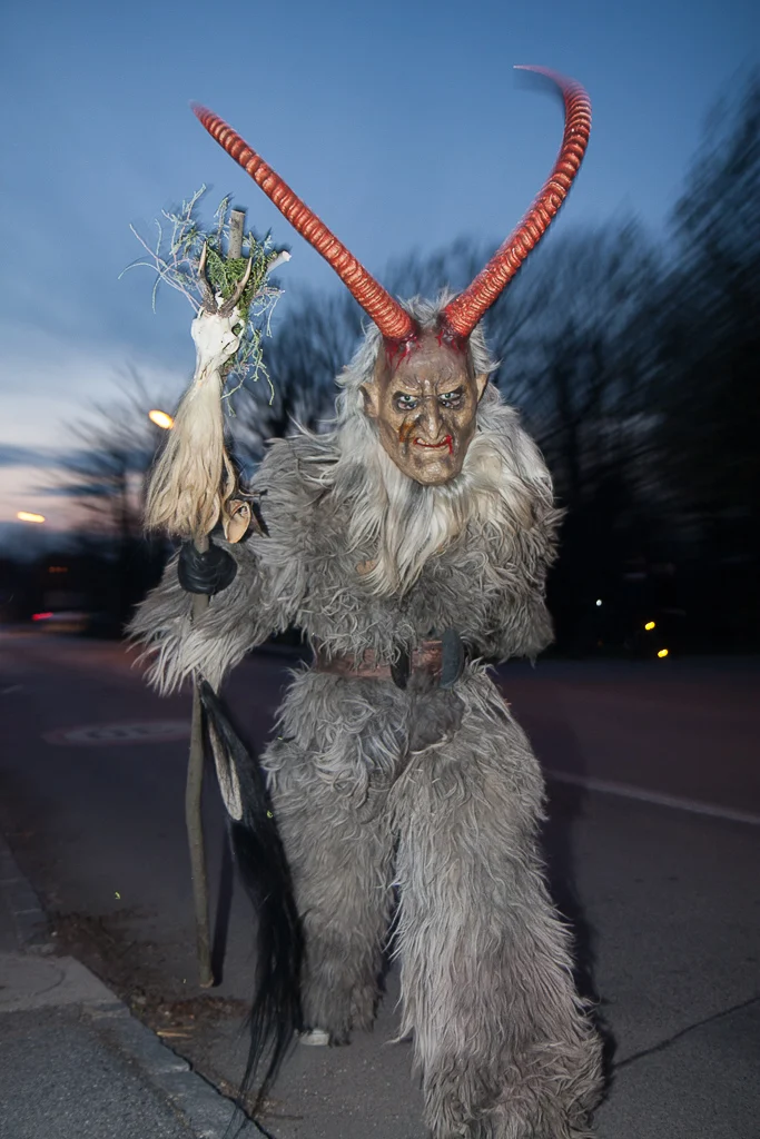 Percht mit handwerklich gestalteter Maske und roten Hörnern beim Winteraustreiben in Enzersdorf